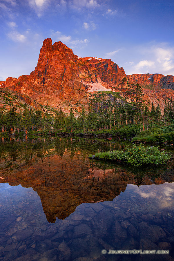 I had first hiked to Lake Helene about 5 years prior on a crisp fall day and on that visit became one of my favorite locations in Rocky Mountain National Park.  I took another opportunity to visit this scenic location, this time in the summer.  As the sun rose, Notchtop glowed with a brilliant warmth similar to what I had witnessed on the prior visit.  This year, however, the water was calm and reflected the beautiful scene that was before me. - Rocky Mountain NP Photography