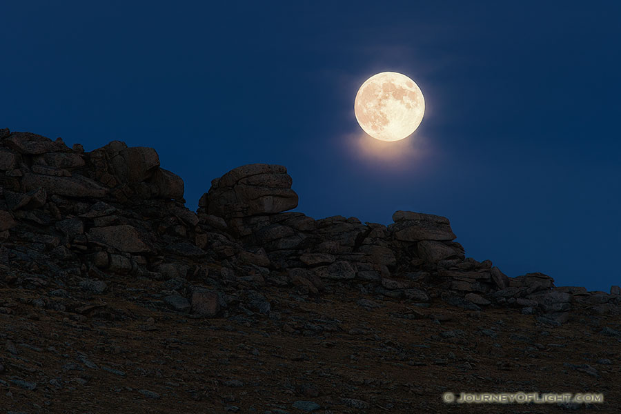 As the sun descended in the west, an eerie glow began to illuminate the east.  Within a few minutes the glowing orb of the moon rose silently above the tundra. - Colorado Photography