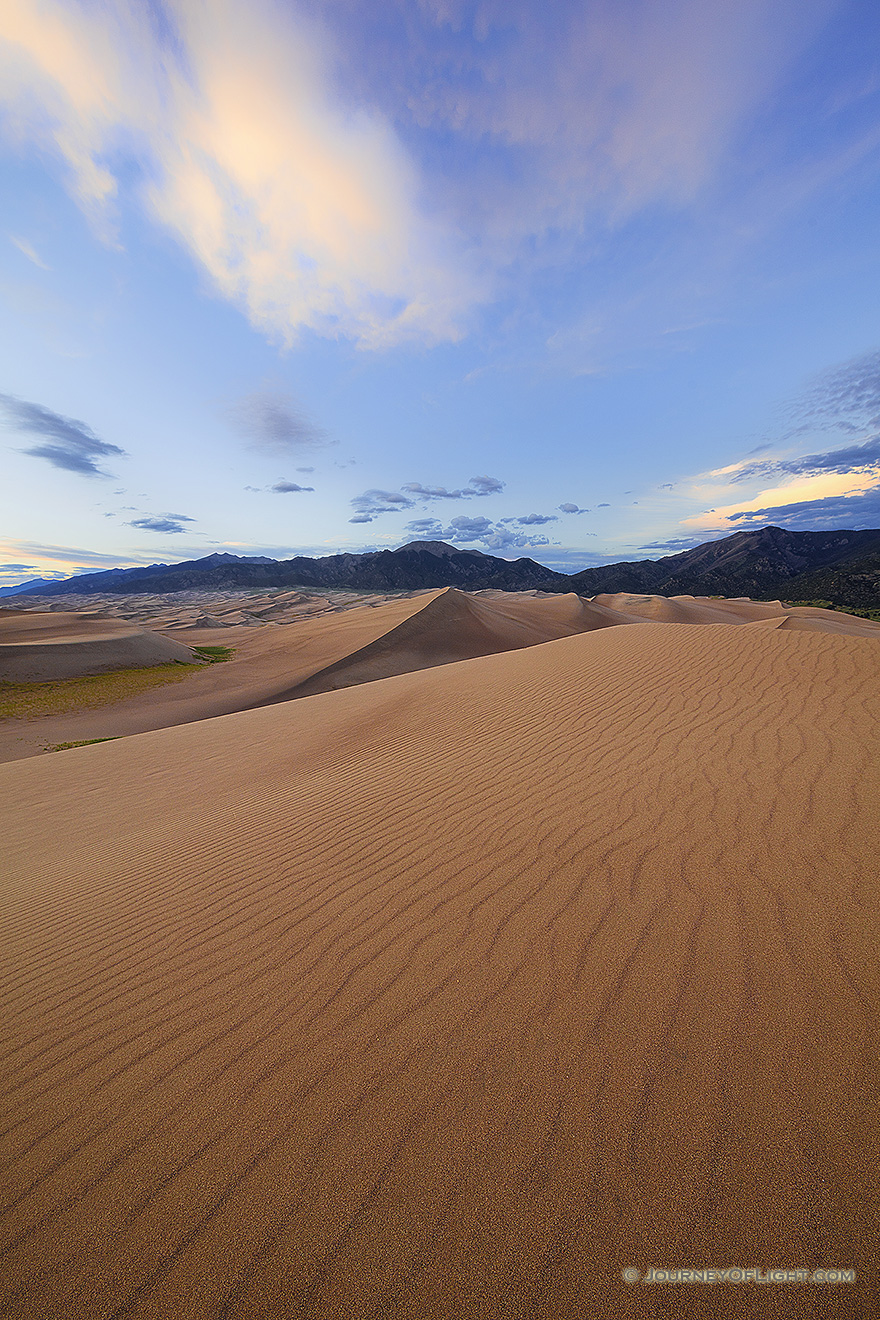 A rare combination of geologic forces combine to create these massive dunes, the largest in North America.  Rising in the distance is Mt. Herard, one of the tallest mountains of the San Juan range. - Great Sand Dunes NP Picture