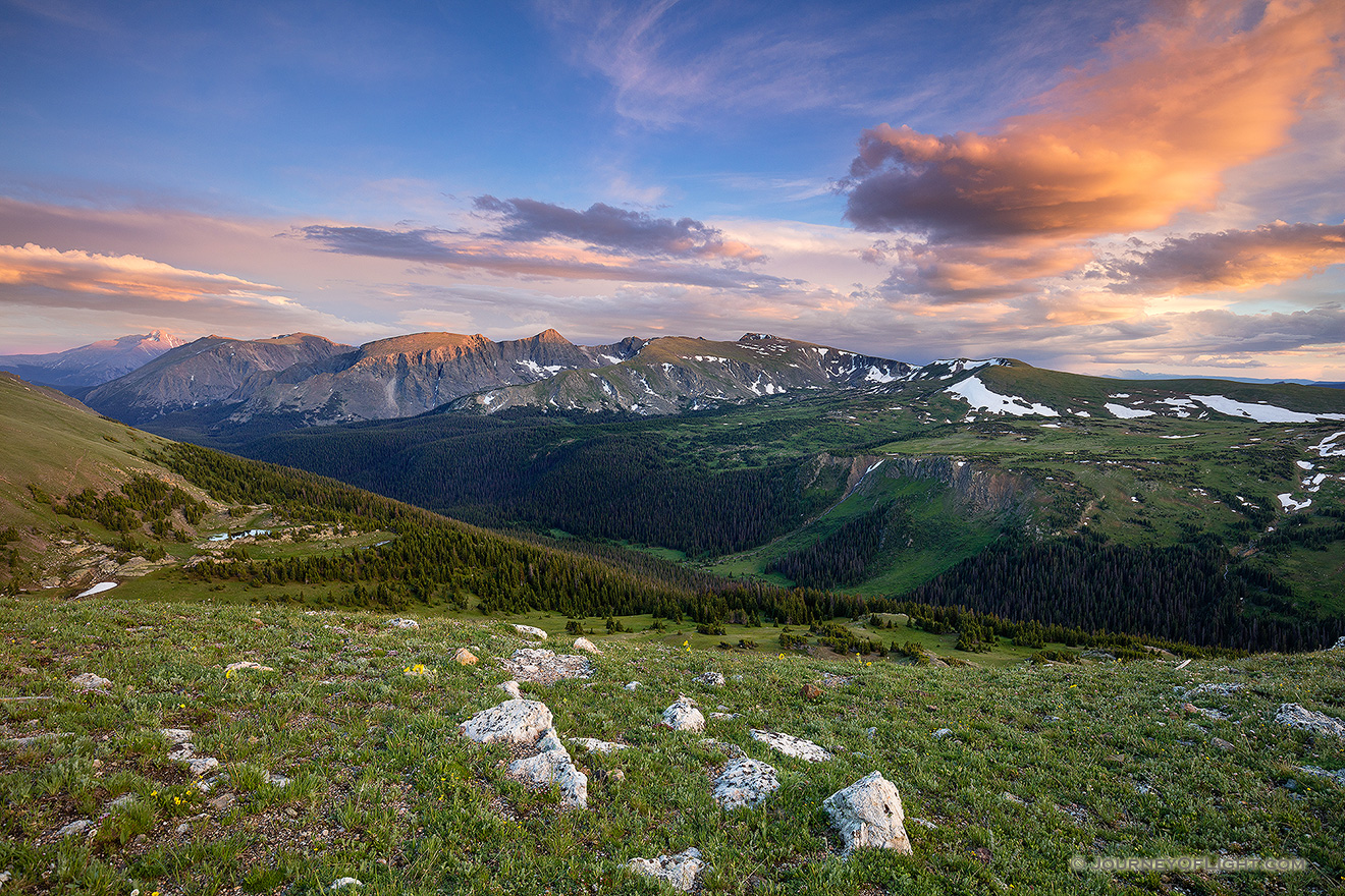 Clouds gather above the tops of the mountains in Rocky Mountain National Park as the last warm glow of sunset grazes the peaks. - Colorado Picture