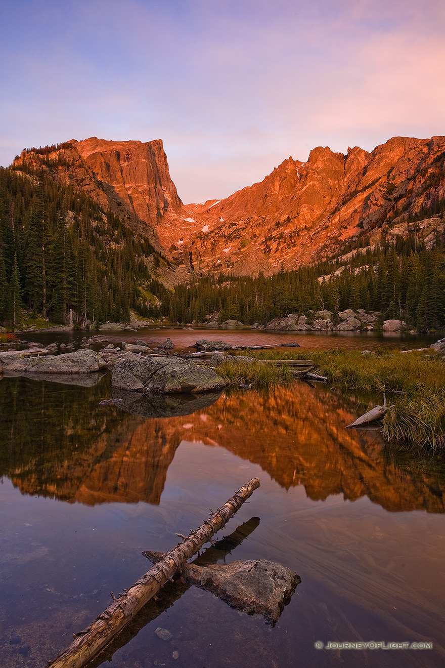 Early on a cool autumn morning, Dream Lake glows with the reflected light of the rising sun. - Rocky Mountain NP Picture