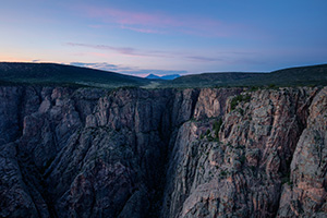 As twilight descends into the Black Canyon of the Gunnison blue hues dominate the sky and the walls. - Colorado Landscape Photograph