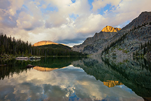 Mountains glow with the last light of a cool autumn day while an almost perfect reflection shimmers in Nanita Lake. - Colorado Landscape Photograph