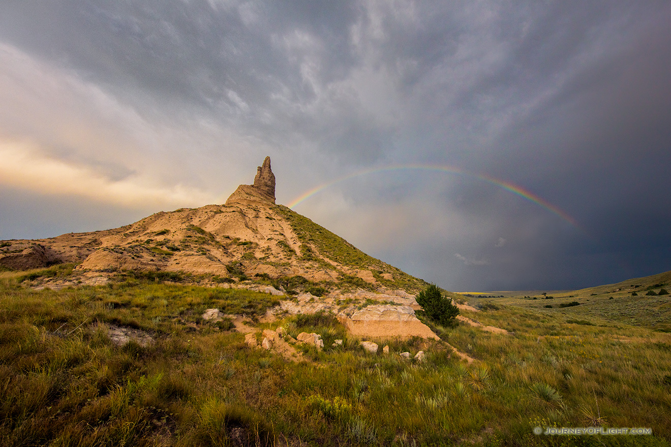 A scenic landscape Nebraska photograph of a rainbow over Chimney Rock in western Nebraska. - Nebraska Picture