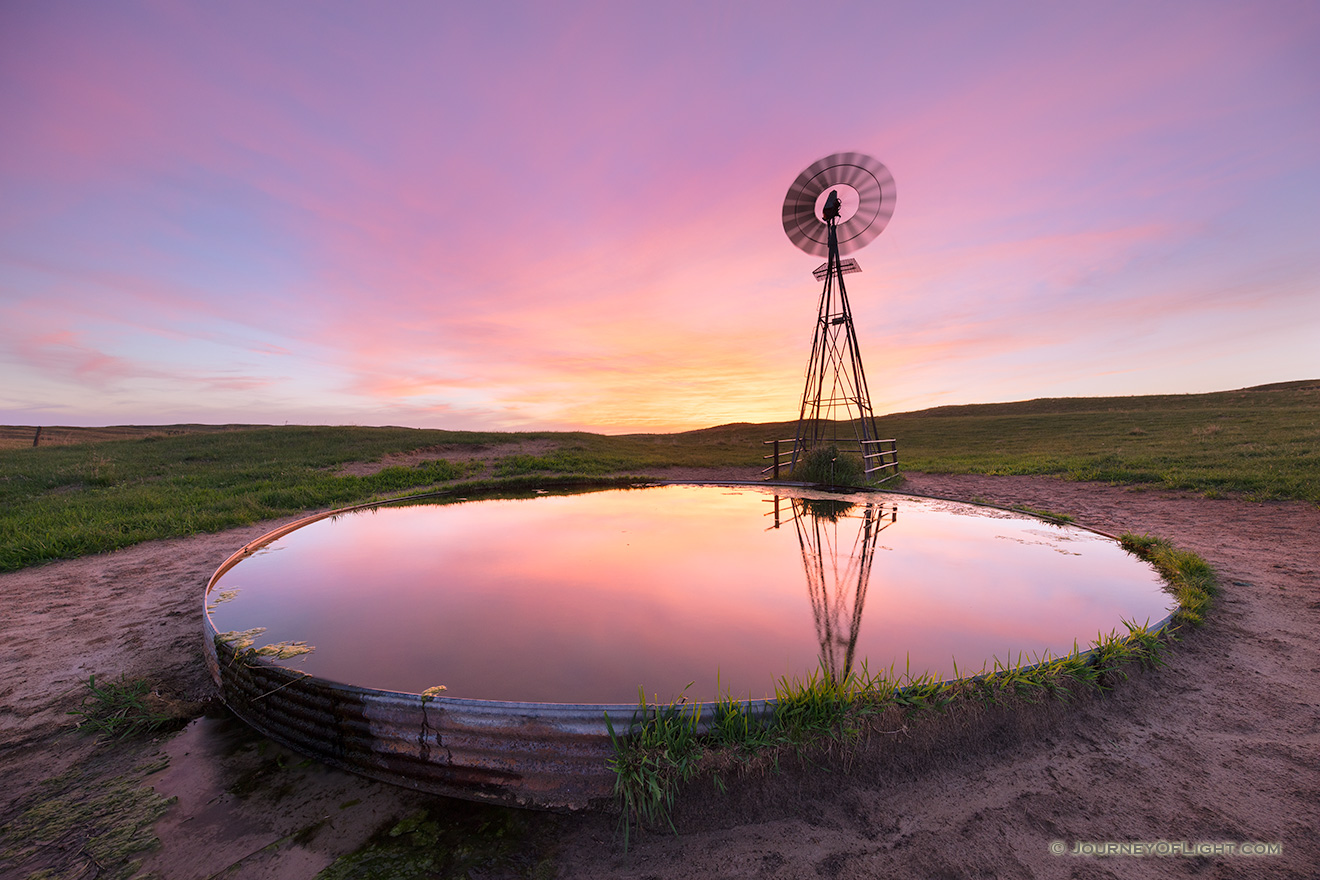 A photograph of a windmill in the Nebraska Sandhills during a summer sunset. - Nebraska Picture