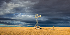 Scenic landscape panoramic photograph of a windmill and a storm at Oglala National Grasslands. - Nebraska Photograph