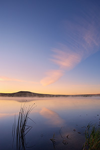On a cool autumn morning, mist rises from Meng Reservoir on the Oglala Grassland while a single clouds hovers over the lake. - Nebraska Photograph
